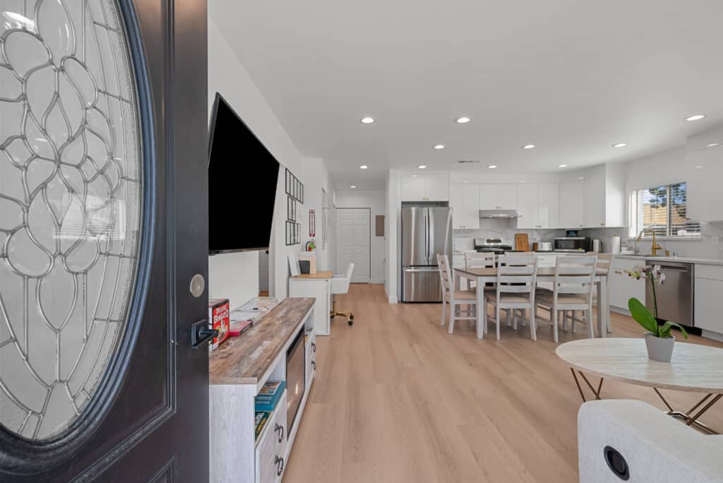 kitchen and living room area featuring a large glass door that opens to an outdoor space.