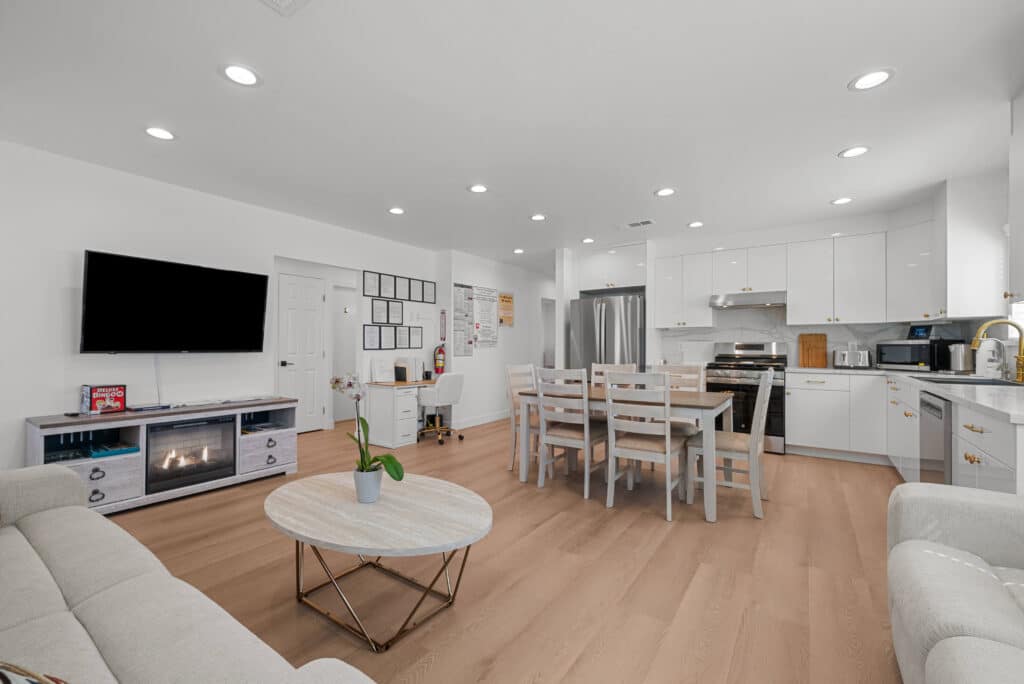 A modern living room featuring white walls, wooden floors, and a clean, minimalist design.