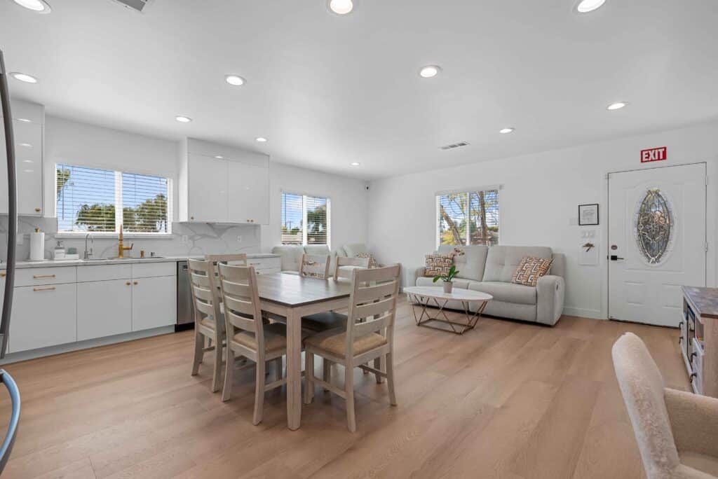 Bright kitchen and dining area with hardwood floors, showcasing a cozy and inviting atmosphere.