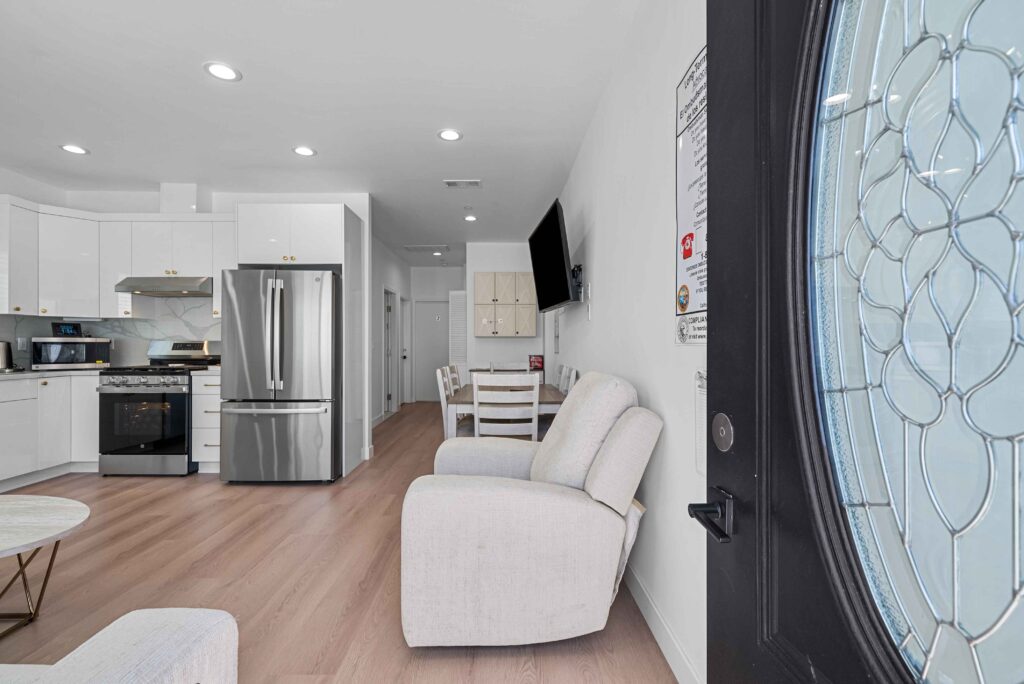 kitchen and living room area featuring a large glass door that opens to an outdoor space.